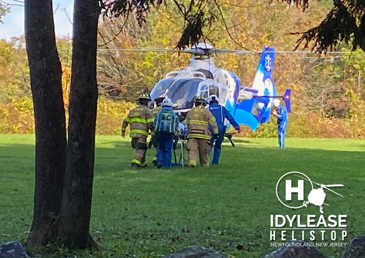 First responders transferring a stretcher to an air-medical helicopter at Idylease Helistop